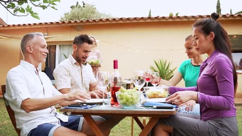 Friends Enjoying Food and Wine at Garden Party