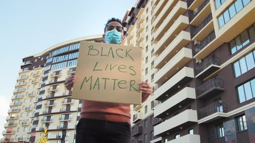 Man Holds Black Lives Matter Sign in City