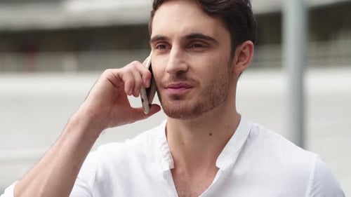 Man Talking on Mobile Phone in City