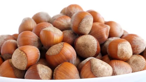 Pile of Hazelnuts Rotating on White Background