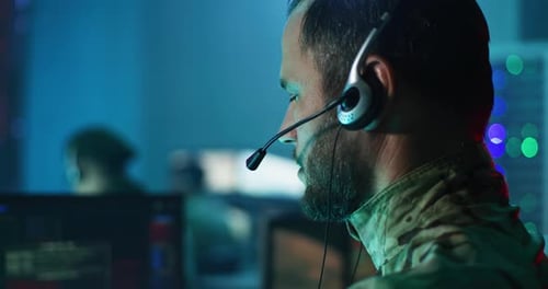 Military Man Giving Commands in Control Center