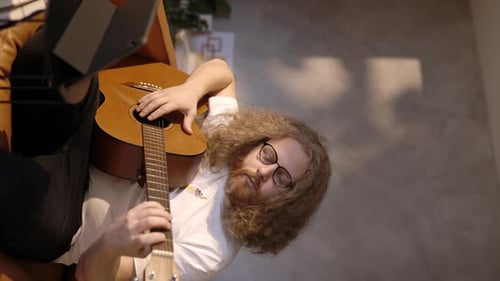 Man Playing Acoustic Guitar Indoors Close Up