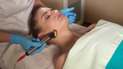Woman in Spa Salon Getting Facial Rejuvenation Procedure