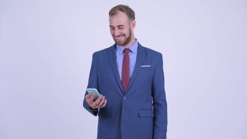 Businessman Uses Smart Phone and Smiles