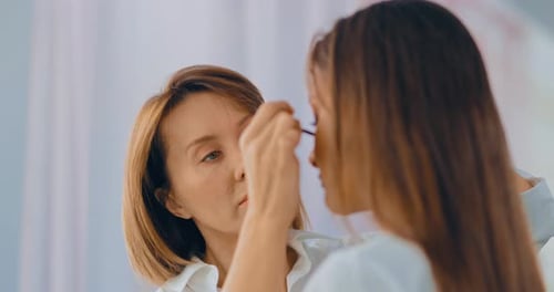 Woman Getting Mascara Applied for Natural Look