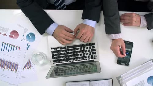 Business Colleagues Working Together at Desk, Overhead Shot