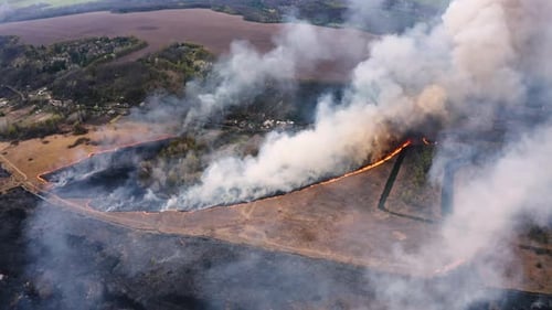 Aerial top view of smoking wildfire. Large smoke clouds