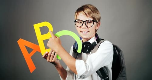 Child Holding ABC Letters in a Studio