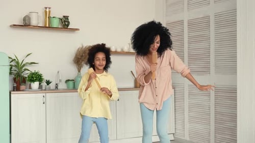Mother and Child Singing Together in Kitchen