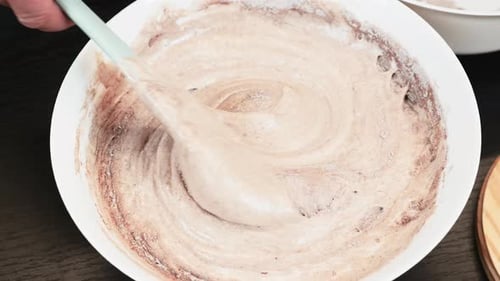 Adding Powdered Ingredient to Cake Batter with Spatula
