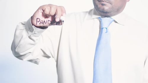 Man Writes Pandemic on Clear Surface