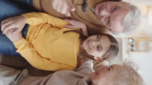 Grandparents and Child Smiling Together Indoors