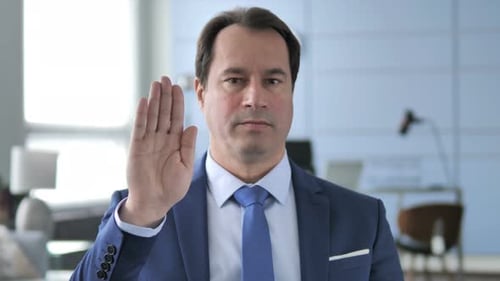 Man Making Stop Gesture with Hand in Office