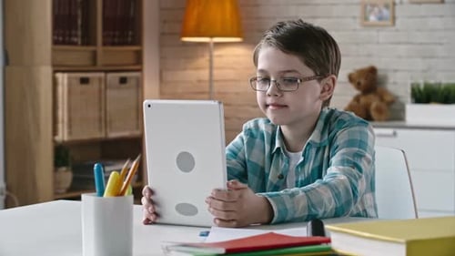 Kid Grimacing at Camera of Tablet