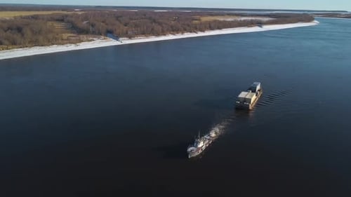 Barge floating on a wide river