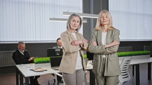 Confident Women Stand in Modern Corporate Office