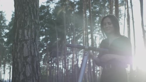 Woman Using Scooter in Forest Sunlight