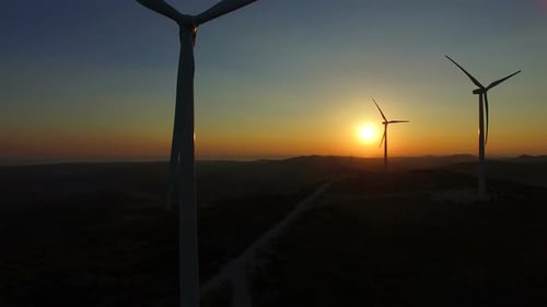 Flying close to windmill blades at dusk