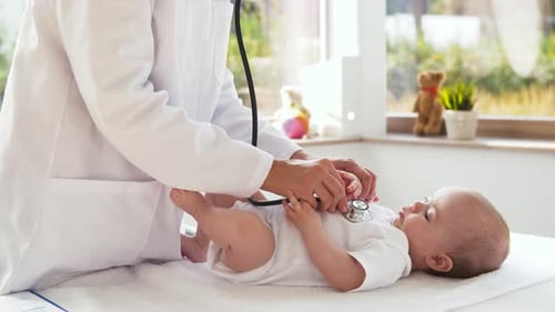 Doctor Examines Infant with Stethoscope in Hospital