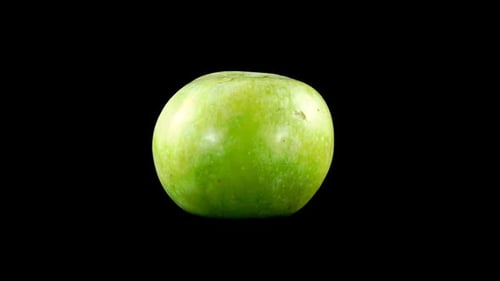 Green Apple Rotating on Black Background