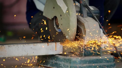 4K Asian man worker working on electric angle grinding machine cutting steel bar