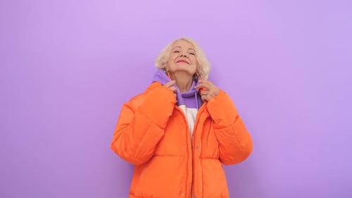 Cheerful Old Lady Happy with Life Posing for the Camera in the Studio on an Isolated Background