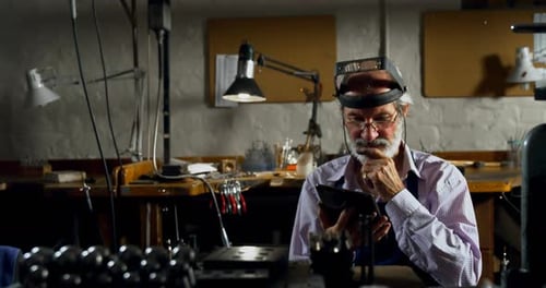 Goldsmith using digital tablet in workshop 4k