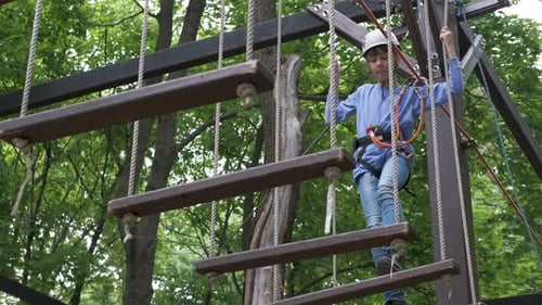 Child Navigating Ropes Course in Outdoor Setting