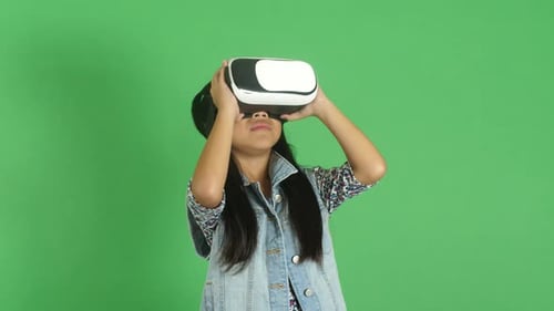 Girl Enjoys Virtual Reality Headset on Green Screen
