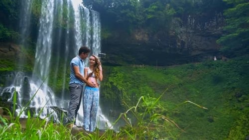 Romantic Couple Taking Selfie at Lush Waterfall