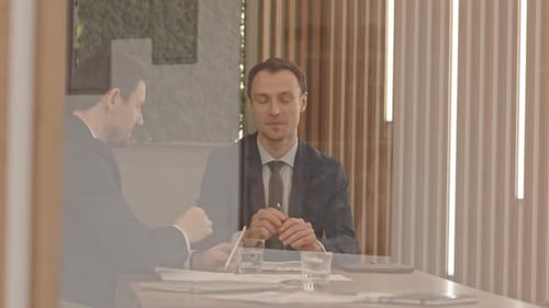 Businessmen Meeting and Discussing in Modern Office