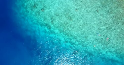 Tropical flying travel shot of a sunshine white sandy paradise beach and turquoise sea background