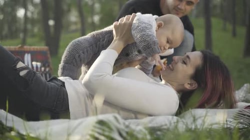 Mother and Baby Playing in Grassy Rural Field