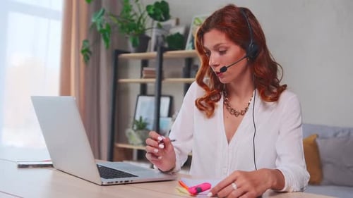 Woman Working From Home Taking Notes
