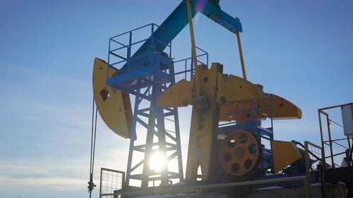Oil Pump Jack Operating with Blue Sky