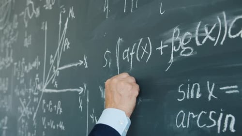 Writing Mathematical Equations with Chalk on Board