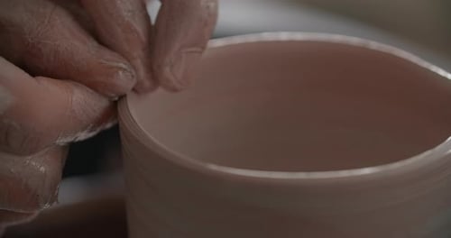 Close Up View Potter Sculpts a Ceramic Jug on a Potter's Wheel the Potter Makes Even Edge of a Clay