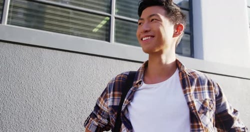 Handsome Young Man Smiles in City Environment