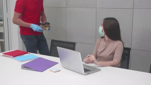 Courier man in face mask for protection covid-19 carrying delivery food with customer woman.