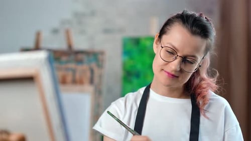 Happy Creative Young Female Painter Focused Working at Art Studio Medium Closeup