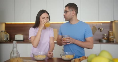 Couple Eating Breakfast Together in Modern Kitchen