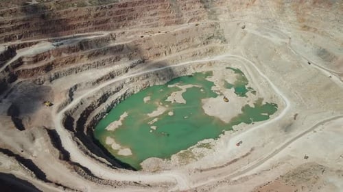 Aerial View Industrial of Opencast Mining Quarry with Lots of Machinery at Work Extracting Fluxes
