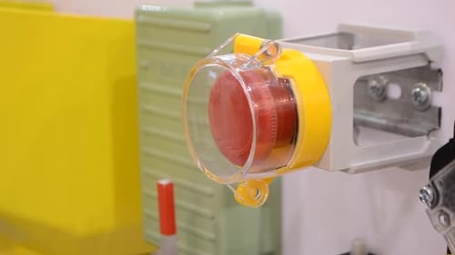The Person Clicks a Finger at the Big Red Stop Button