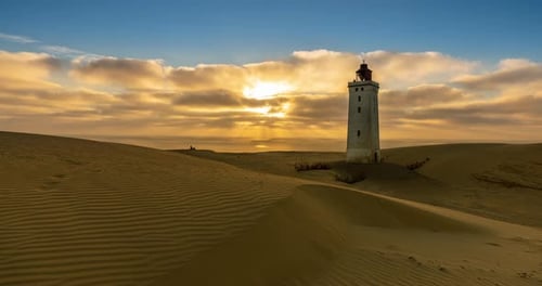 Lighthouse on Sand Dunes at Sunset