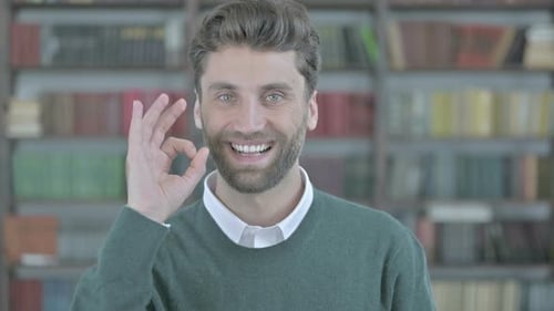 Smiling Man Gives an OK Hand Gesture