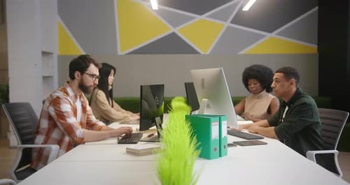 Team Working at Computers in Modern Office