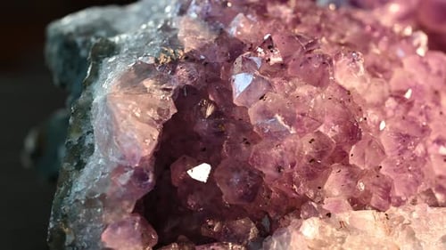 macro view of impurities in an amethyst. Slow beautiful glimmer as the stone is shown by slider