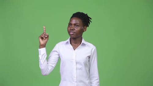 Young Woman Has Idea, Raises Finger on Green Screen
