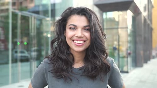 Happy Young Mixed Race Woman Standing on Street Looking at Camera Portrait