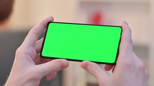 Watching on Horizontal Green Chroma Key Screen of Smartphone